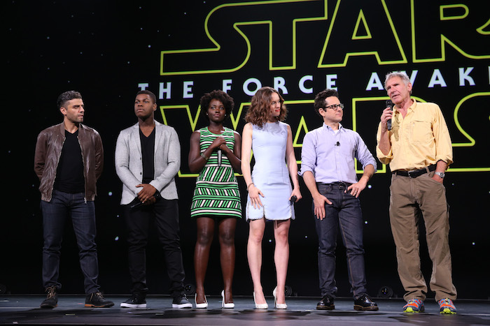 ANAHEIM, CA - AUGUST 15:  (L-R) Actors Oscar Isaac, John Boyega, Lupita Nyong'o, Daisy Ridley, director J.J. Abrams and actor Harrison Ford of STAR WARS: THE FORCE AWAKENS took part today in "Worlds, Galaxies, and Universes: Live Action at The Walt Disney Studios" presentation at Disney's D23 EXPO 2015 in Anaheim, Calif.  (Photo by Jesse Grant/Getty Images for Disney) *** Local Caption *** Oscar Isaac; John Boyega; Lupita Nyong'o; Daisy Ridley; J.J. Abrams; Harrison Ford