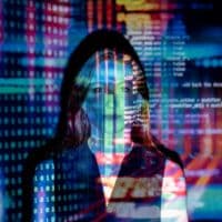 A woman with digital code projections on her face, representing technology and future concepts.