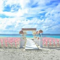 Elegant beach wedding setup in Maldives with floral decor and ocean view.