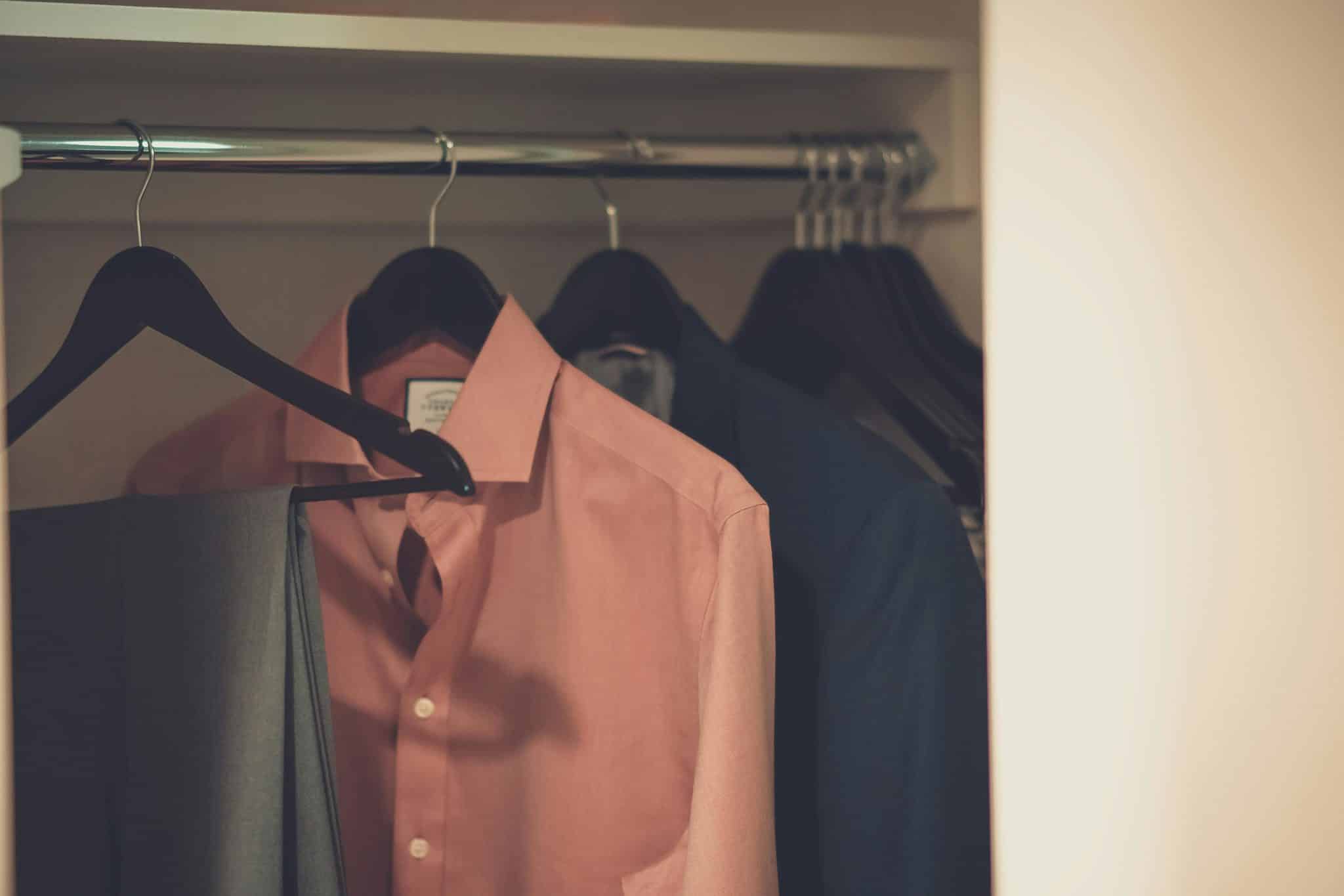 Close-up Photo of Clothes hanging in Wardrobe