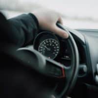 person in black long sleeve shirt driving car