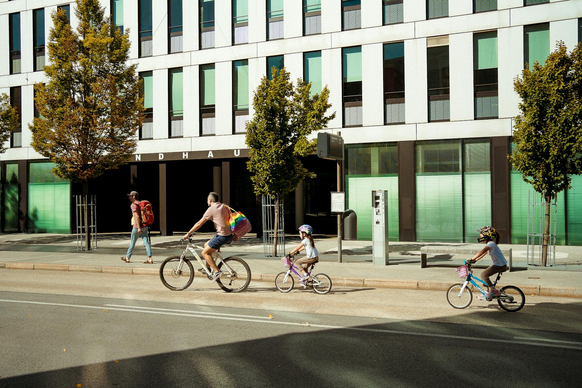 Family biking on city street in Innsbruck, Austria