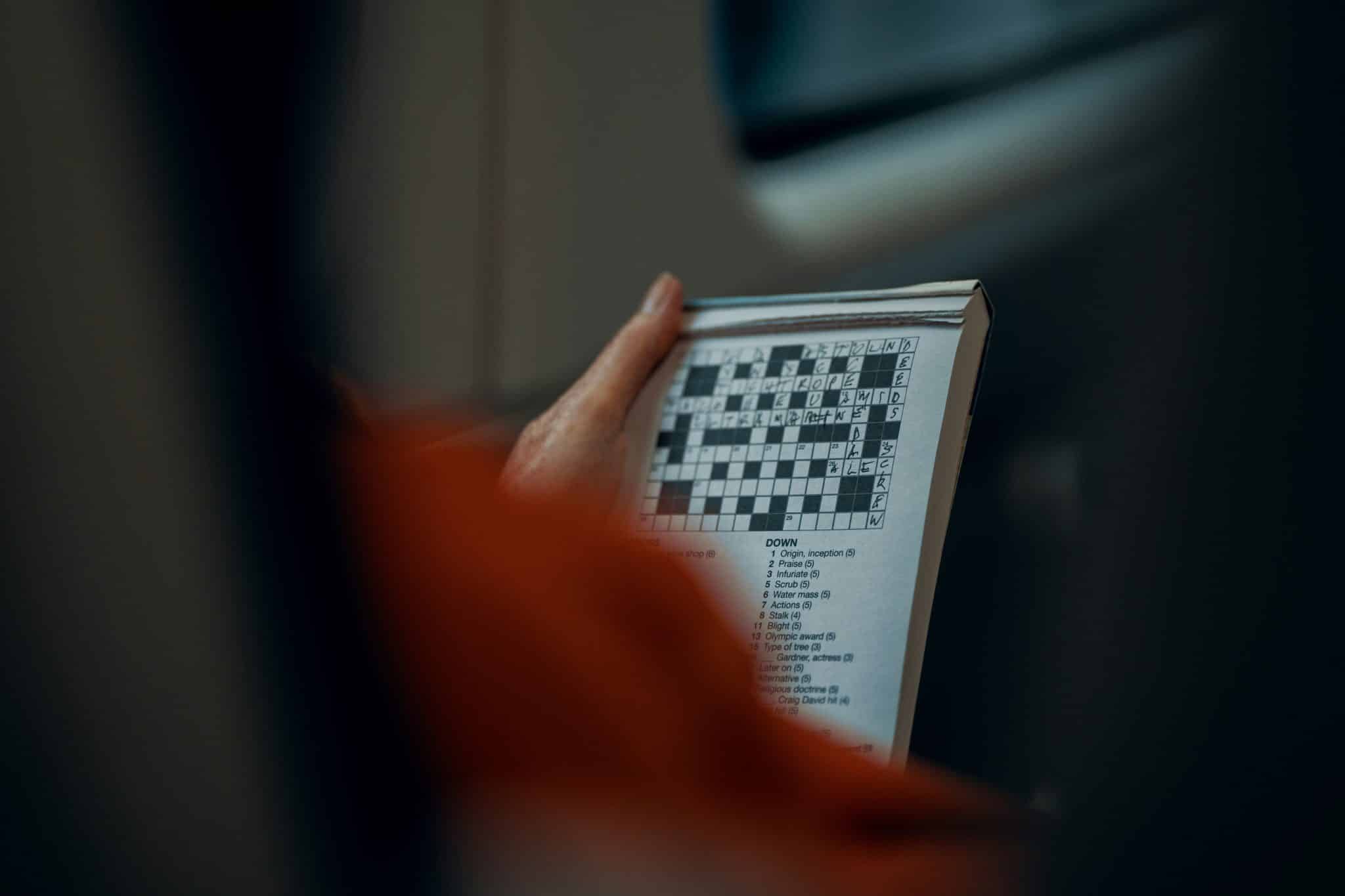 Woman doing a crossword on the train