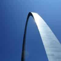 Iconic Gateway Arch in St. Louis captured against a clear blue sky.