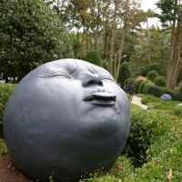 gray round statue near green trees during daytime