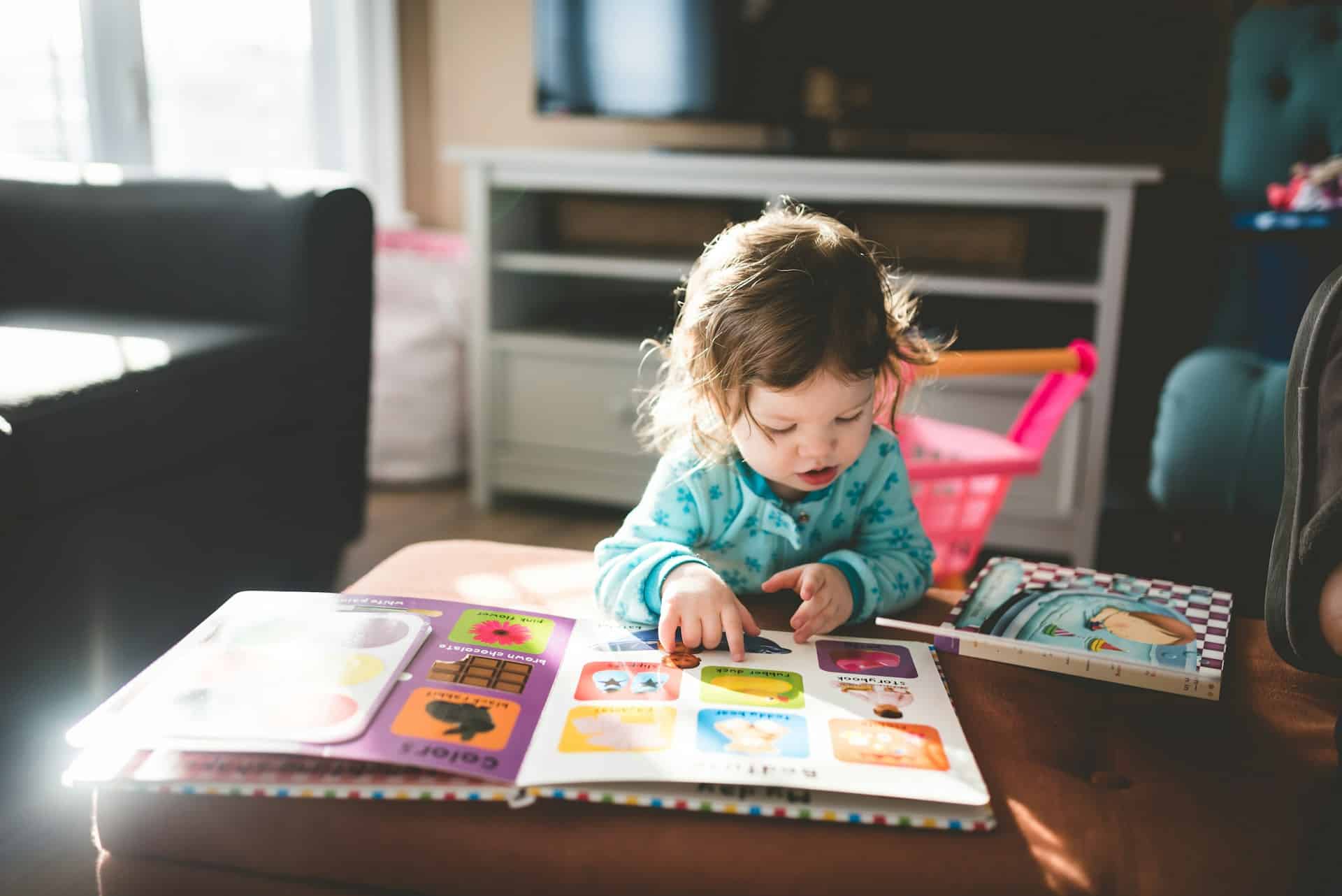 photo of books, book, baby, and reading by Stephen Andrews